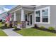 Charming front porch with classic columns, lush landscaping, and a cozy entrance at 1115 Fitzgerald Ct, Summerville, SC 29485