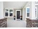 Charming front porch with classic columns, lush landscaping, and a cozy entrance at 1115 Fitzgerald Ct, Summerville, SC 29485