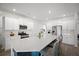 Bright, modern kitchen with white cabinets, stainless steel appliances, large island, and bar stool seating at 1115 Fitzgerald Ct, Summerville, SC 29485