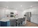 Modern kitchen featuring white cabinets, stainless steel appliances, a spacious island, and stylish bar stools at 1115 Fitzgerald Ct, Summerville, SC 29485