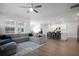 Open concept living room features hardwood floors, lots of natural light, and flows to the kitchen at 1115 Fitzgerald Ct, Summerville, SC 29485