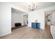 Open-concept living space featuring modern lighting, light wood floors, and white walls at 1115 Fitzgerald Ct, Summerville, SC 29485
