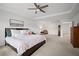 Comfortable carpeted main bedroom featuring a ceiling fan and tray ceiling at 1115 Fitzgerald Ct, Summerville, SC 29485