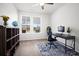 Bright home office with desk, chair, bookcase, and windows offering lots of natural light at 1115 Fitzgerald Ct, Summerville, SC 29485