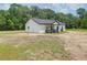 Charming new home with a black roof, light siding and a cozy front porch, offering a modern touch at 112 Southsong Ln, Goose Creek, SC 29445