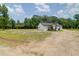 Quaint home with a covered front porch, complemented by an expansive yard with lush surroundings at 112 Southsong Ln, Goose Creek, SC 29445