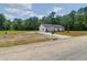 New house with a long driveway surrounded by trees and land awaiting its transformation to green lawns, garden or whatever you desire at 112 Southsong Ln, Goose Creek, SC 29445