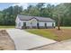 Beautifully built home displays a contemporary exterior, a long driveway, and a well-maintained lawn with green grass at 112 Southsong Ln, Goose Creek, SC 29445