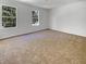 Spacious bedroom featuring neutral carpet, white walls, and natural light from two windows at 120 Apache Dr, Summerville, SC 29483