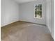 Bright bedroom featuring neutral carpeting and a window view of the outdoors at 120 Apache Dr, Summerville, SC 29483