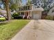 Two-story home with red front door, white garage door and driveway at 120 Apache Dr, Summerville, SC 29483