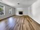 Bright and airy living room showcasing wood floors, a fireplace, and natural light from windows at 120 Apache Dr, Summerville, SC 29483