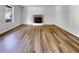 Spacious living room showcasing wood floors, fireplace, and natural light from a window at 120 Apache Dr, Summerville, SC 29483