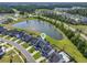 An aerial view shows a blue marker above a lovely house by a lake, in a lush green community at 120 Haverhill St, Summerville, SC 29486