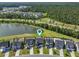 Aerial view of a home by the lake, close to a forest, and surrounded by well-maintained lawns at 120 Haverhill St, Summerville, SC 29486