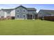 Spacious backyard showcases the blue home with a well-kept lawn, ideal for outdoor activities at 120 Haverhill St, Summerville, SC 29486