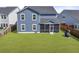 Grassy backyard and blue home, featuring a large screened porch perfect for relaxing at 120 Haverhill St, Summerville, SC 29486