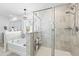 Bright bathroom showcasing a glass-enclosed shower, soaking tub, and modern finishes at 120 Haverhill St, Summerville, SC 29486