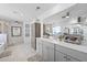 Bright bathroom featuring double sinks with white countertops, wood cabinets, and decorative wall accents at 120 Haverhill St, Summerville, SC 29486