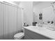 Clean bathroom featuring a white vanity with a shower-tub combo and a decorative mirror at 120 Haverhill St, Summerville, SC 29486