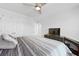 Cozy bedroom features a ceiling fan, white doors, and a modern entertainment center with a TV at 120 Haverhill St, Summerville, SC 29486