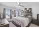Stylish bedroom with a tufted headboard, ceiling fan, and large windows for natural light at 120 Haverhill St, Summerville, SC 29486