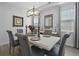 Bright dining room featuring hardwood floors, modern chandelier, and seating for six at 120 Haverhill St, Summerville, SC 29486