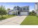 Inviting two-story home featuring blue siding, a two-car garage, and a cozy front porch with ample driveway space at 120 Haverhill St, Summerville, SC 29486