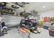 Spacious garage featuring overhead storage, a golf cart, and various tools and equipment at 120 Haverhill St, Summerville, SC 29486