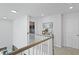 Bright hallway features white railings, neutral walls, and decorative accents at 120 Haverhill St, Summerville, SC 29486