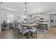 Inviting kitchen with hardwood floors, white cabinets, an island, and dining area at 120 Haverhill St, Summerville, SC 29486