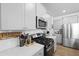 Kitchen with stainless steel appliances, white subway tile backsplash, and grey wood floors at 120 Haverhill St, Summerville, SC 29486