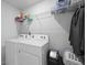 Functional laundry room with side-by-side washer and dryer, and overhead shelving for storage at 120 Haverhill St, Summerville, SC 29486