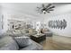 Inviting living area featuring a comfortable gray sectional sofa, stylish decor, and an open view to the kitchen at 120 Haverhill St, Summerville, SC 29486