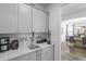 Bright wet bar features quartz countertops and white cabinetry at 120 Haverhill St, Summerville, SC 29486