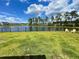 Lush backyard featuring a manicured lawn, serene pond view, and comfortable seating for relaxation and enjoyment at 122 Riley Farms Ct, Summerville, SC 29486