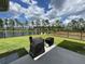 Expansive backyard with a pond view, grilling area, and mature trees, perfect for outdoor entertaining and leisure at 122 Riley Farms Ct, Summerville, SC 29486