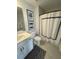 Stylish bathroom with a white vanity, framed art, and a patterned shower curtain, creating a modern and inviting space at 122 Riley Farms Ct, Summerville, SC 29486
