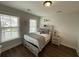 Cozy bedroom featuring hardwood floors, natural light, and neutral décor, creating a comfortable and inviting space at 122 Riley Farms Ct, Summerville, SC 29486