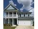 Elegant two-story home with a charming front porch and well-maintained landscaping, showcasing curb appeal at 122 Riley Farms Ct, Summerville, SC 29486