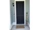 Welcoming front door featuring a modern black finish, stylish decor, and a 'Home Sweet Home' doormat at 122 Riley Farms Ct, Summerville, SC 29486
