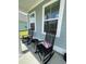 Cozy front porch with rocking chairs and a small table, perfect for relaxing and enjoying the outdoors at 122 Riley Farms Ct, Summerville, SC 29486