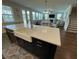 Modern kitchen island with a white countertop, farmhouse sink, and open view to the living room at 122 Riley Farms Ct, Summerville, SC 29486