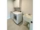 Functional laundry room equipped with a washer, dryer, utility sink, and ample storage cabinets for convenience at 122 Riley Farms Ct, Summerville, SC 29486