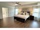 Primary bedroom with a ceiling fan, tray ceilings, and many windows for natural light at 122 Riley Farms Ct, Summerville, SC 29486