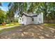 This cozy backyard has an outdoor fire pit with seating and beautiful mature trees offering plenty of shade at 1248 Sumner Ave, North Charleston, SC 29406