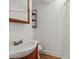 Modest bathroom featuring wooden vanity, decorative shelves, and a framed mirror at 1248 Sumner Ave, North Charleston, SC 29406