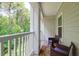 Relaxing balcony space with comfortable seating and a view of the surrounding green foliage and nature at 1300 Park West Blvd # 512, Mount Pleasant, SC 29466