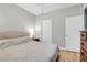 Cozy bedroom with neutral tones, featuring a queen-sized bed, hardwood floors, and ample closet space at 1300 Park West Blvd # 512, Mount Pleasant, SC 29466