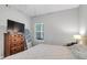 Bedroom featuring a wooden dresser with a mirror, a bed and a large window that provides natural light at 1300 Park West Blvd # 512, Mount Pleasant, SC 29466